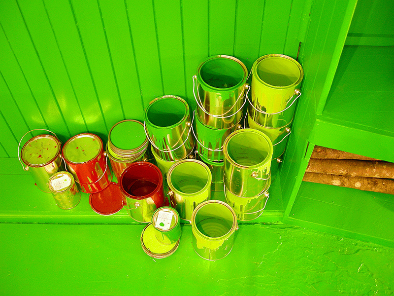 Empty green and red paint cans lean against the wall image from SET THE CONTROLS FOR THE HEART OF THE SUN, installation at WRKS DVSN, by Kennedy Telford, 2006.
