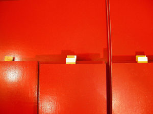 Red wall image from SET THE CONTROLS FOR THE HEART OF THE SUN, installation at WRKS DVSN, by Kennedy Telford, 2006.
